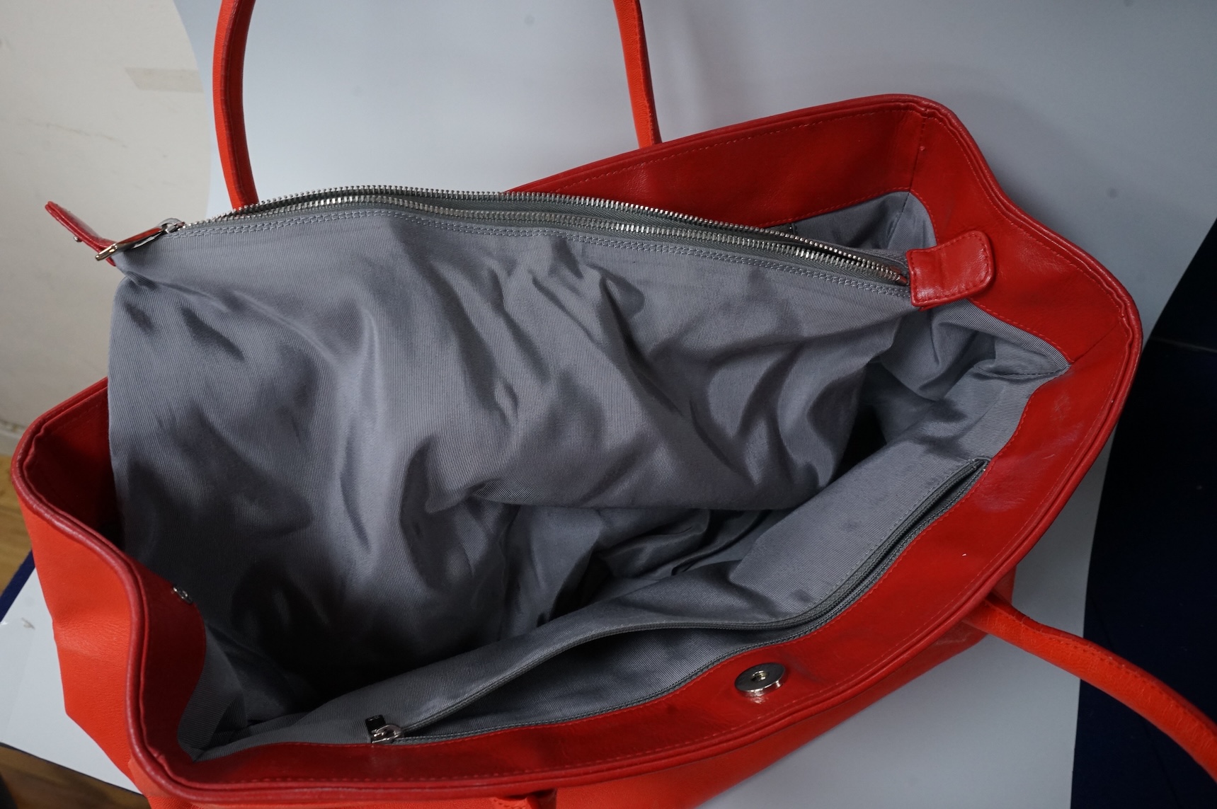 A Chanel red leather Executive Cerf tote bag with silver hardware, with original receipt and dust cover, 41cm wide, Provenance: Purchased by the vendor in Dubai, Chanel